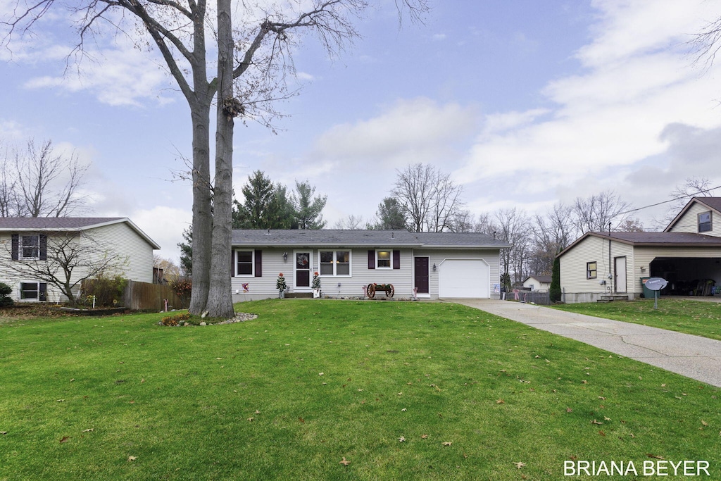 single story home featuring a garage and a front yard