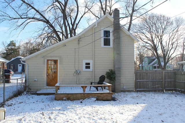 view of snow covered back of property