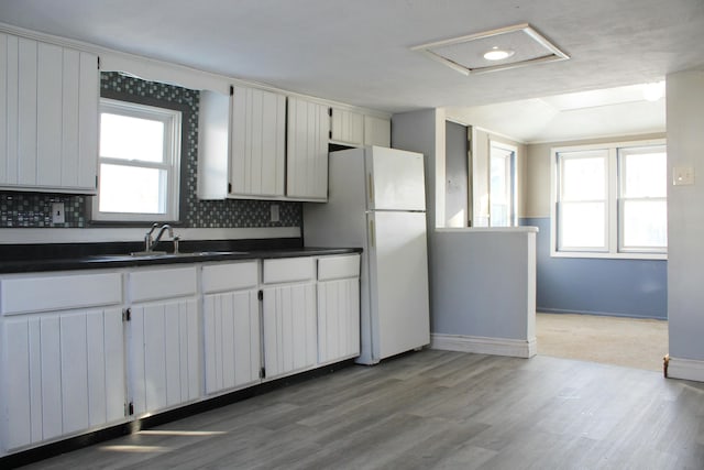 kitchen with backsplash, white cabinetry, a healthy amount of sunlight, and sink