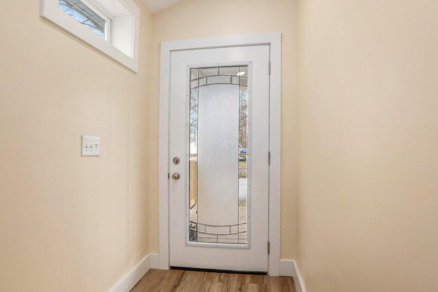 doorway to outside with light wood-type flooring