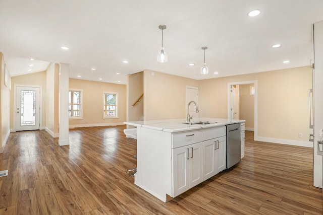 kitchen featuring white cabinetry, a kitchen island with sink, dishwasher, and hardwood / wood-style flooring