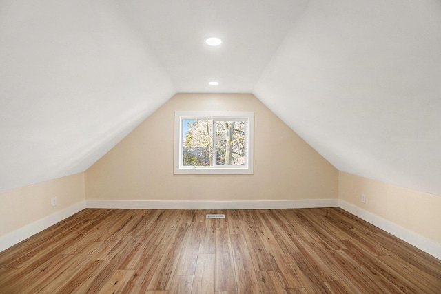 bonus room featuring light hardwood / wood-style floors and vaulted ceiling