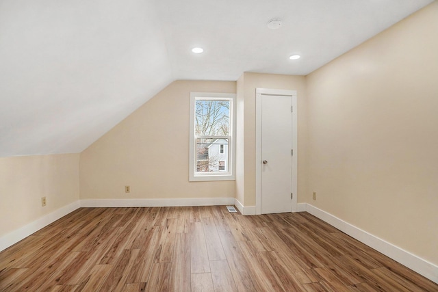 bonus room with light hardwood / wood-style flooring and lofted ceiling