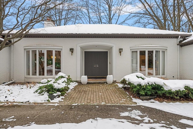 view of snow covered property entrance