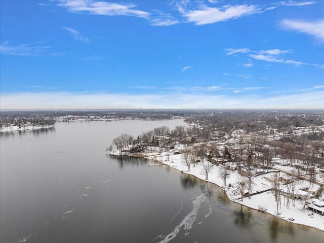 snowy aerial view with a water view