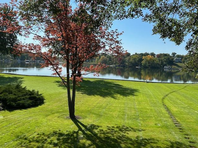 view of property's community featuring a water view and a lawn