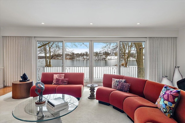 living room with a water view and plenty of natural light