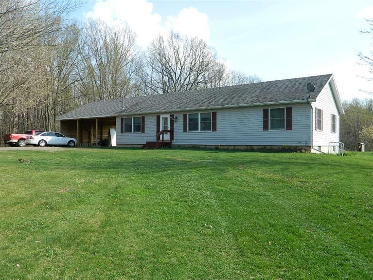 ranch-style home with a front lawn