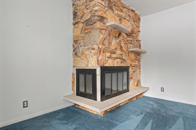 interior details with carpet floors and a stone fireplace