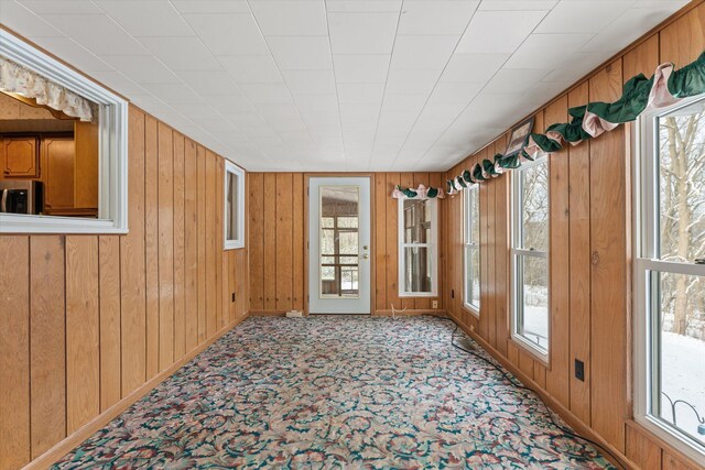 unfurnished sunroom featuring a wealth of natural light