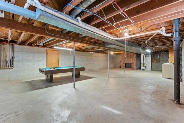 basement featuring washer / dryer, pool table, and heating unit