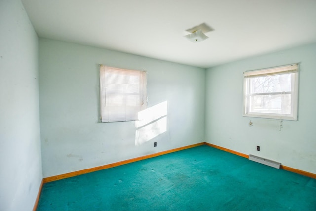 unfurnished room with dark colored carpet