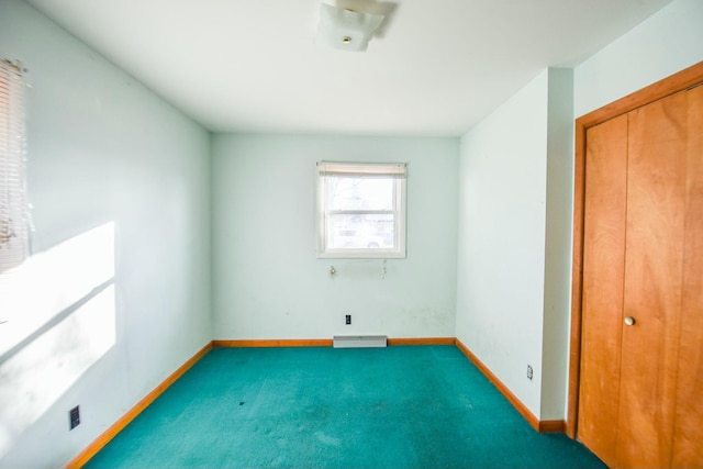 unfurnished bedroom with a closet and dark colored carpet