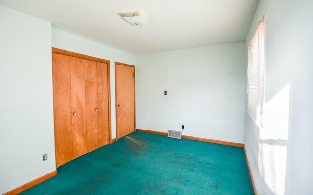 unfurnished bedroom featuring dark colored carpet