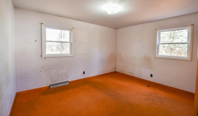 carpeted empty room featuring plenty of natural light