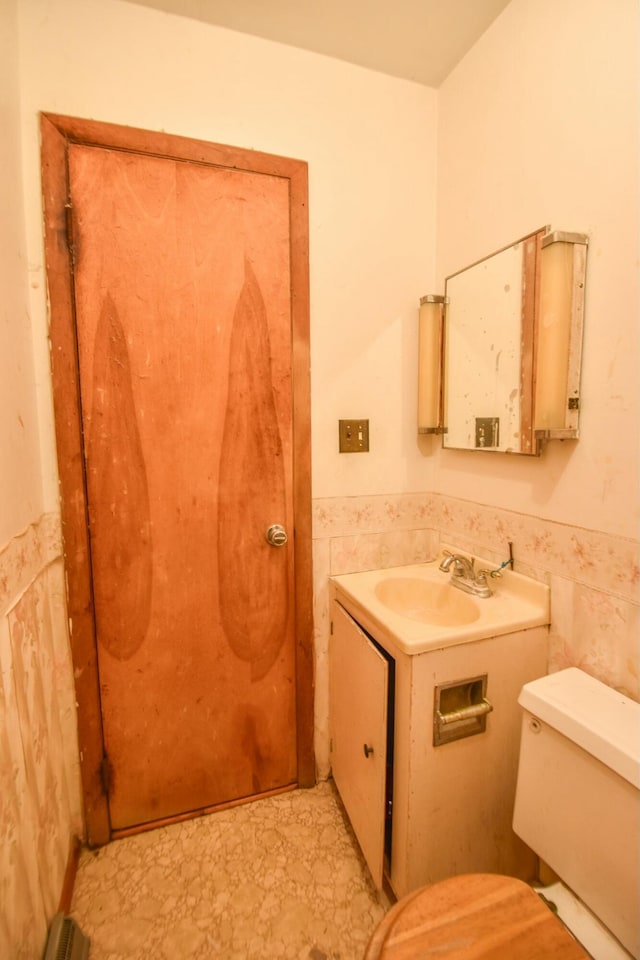 bathroom featuring sink, tile walls, and toilet