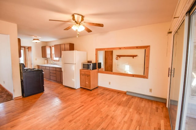 kitchen with a baseboard heating unit, black range, white refrigerator, light hardwood / wood-style flooring, and ceiling fan