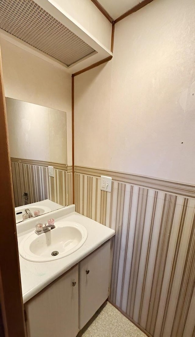 bathroom with vanity and crown molding