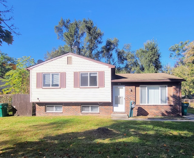 tri-level home with a front yard