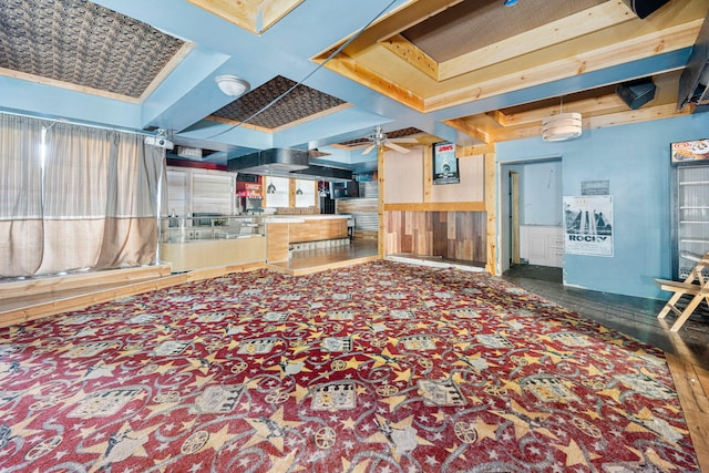 interior space with ceiling fan, beam ceiling, and coffered ceiling