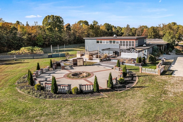 rear view of house with a pergola, a patio area, and a lawn