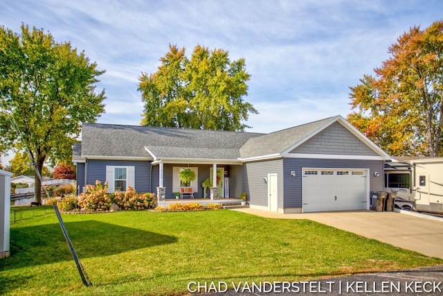 ranch-style house featuring a front yard, a garage, and covered porch