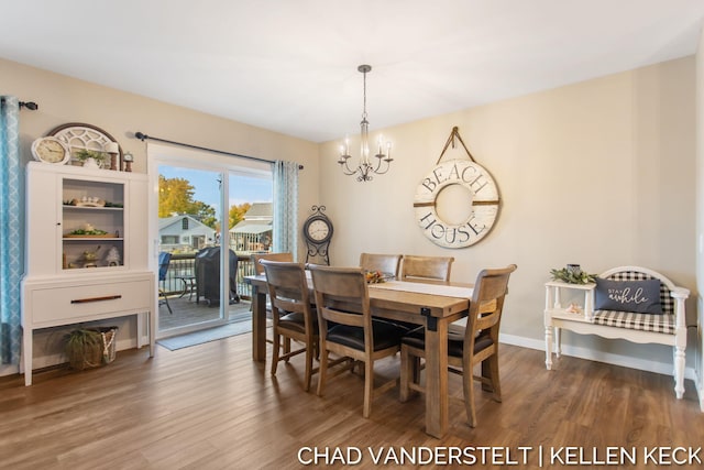 dining area featuring a chandelier and dark wood-type flooring