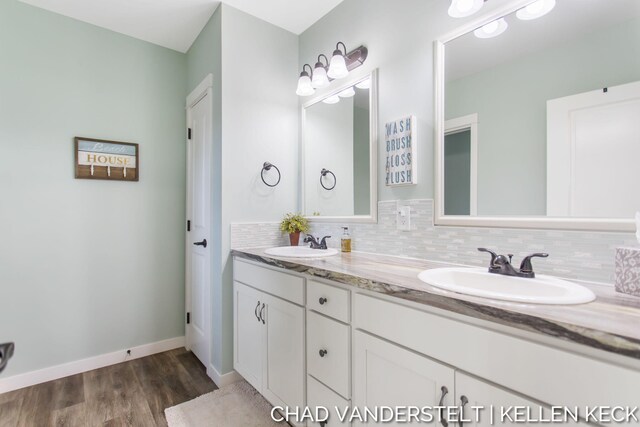 bathroom with decorative backsplash, vanity, and hardwood / wood-style flooring