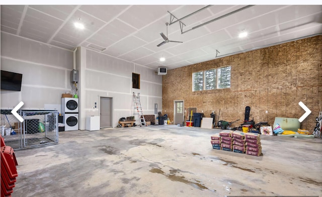 garage with stacked washer / dryer