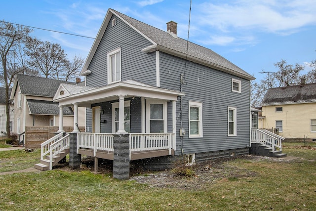 exterior space featuring a lawn and covered porch