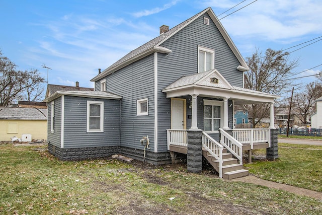 view of front of home with a porch and a front lawn