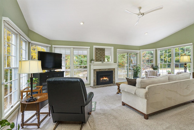 living room featuring light carpet, a healthy amount of sunlight, and lofted ceiling