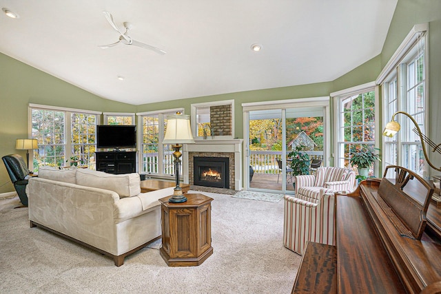 living room with plenty of natural light, ceiling fan, lofted ceiling, and light carpet