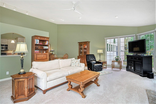 living room with ceiling fan, light carpet, and high vaulted ceiling