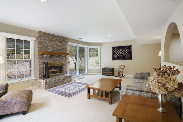 living room with carpet flooring and a fireplace