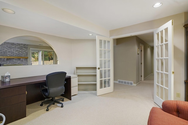 office with french doors and light colored carpet