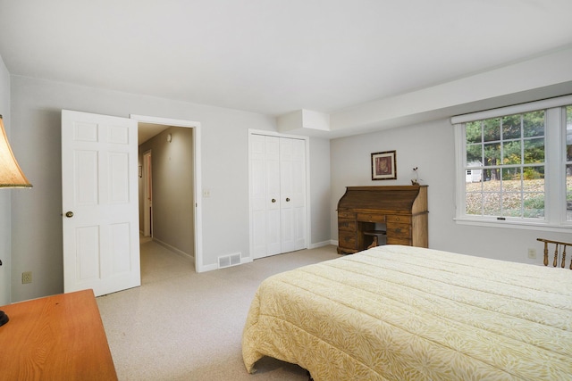 bedroom featuring light carpet and a closet