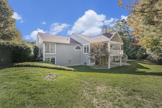 back of house featuring a yard and a patio