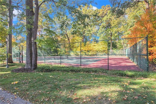 view of sport court with a yard