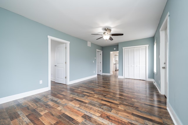 unfurnished bedroom featuring ceiling fan and dark wood-type flooring