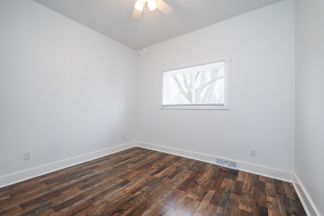 empty room with dark hardwood / wood-style floors and ceiling fan