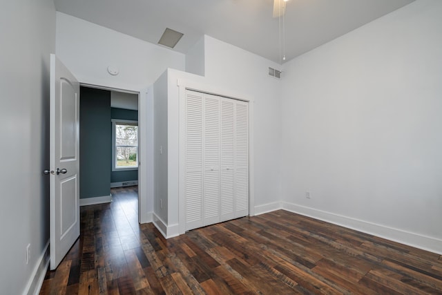 unfurnished bedroom with a closet, ceiling fan, and dark wood-type flooring