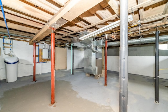 basement with electric panel and heating unit