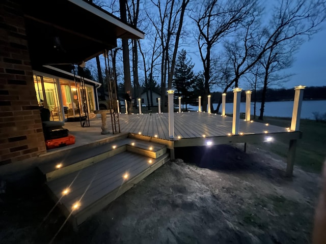 wooden deck featuring a water view