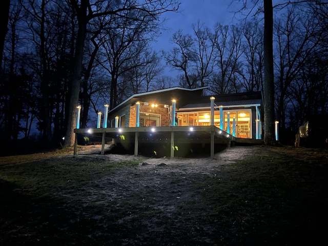 view of back house at twilight