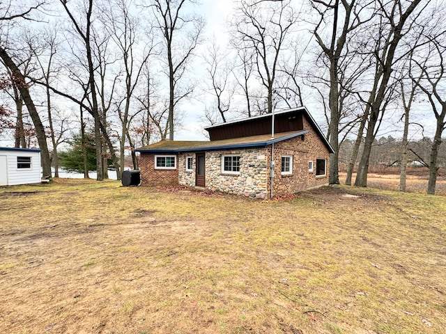 rear view of property with a yard