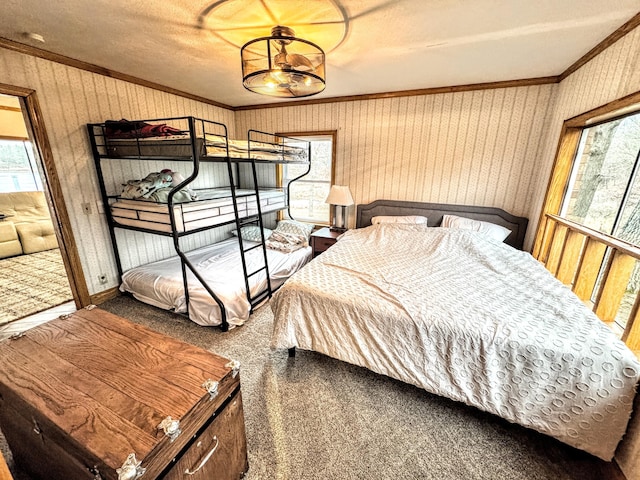 carpeted bedroom with a chandelier and ornamental molding