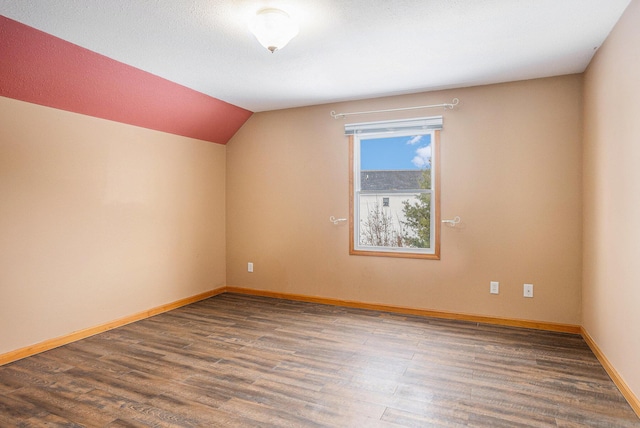 bonus room with wood-type flooring and vaulted ceiling