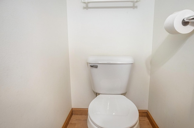 bathroom featuring hardwood / wood-style floors and toilet