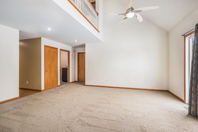 carpeted empty room featuring ceiling fan and lofted ceiling